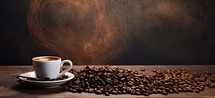 Coffee cup and coffee beans on wooden table over dark background