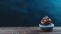 Chocolate cupcake on wooden table with space for your text.