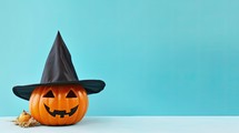 Halloween pumpkin with witch hat on blue background, 3d render