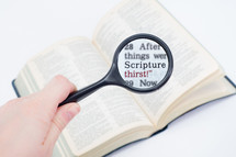 Hand holding a magnifying glass over Bible text "scripture thirst."