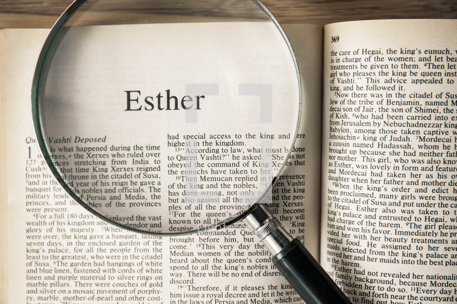 magnifying glass over Bible - Esther 