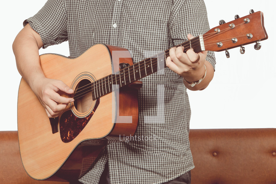a man playing an acoustic guitar 