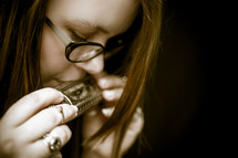 Woman playing a harmonica.