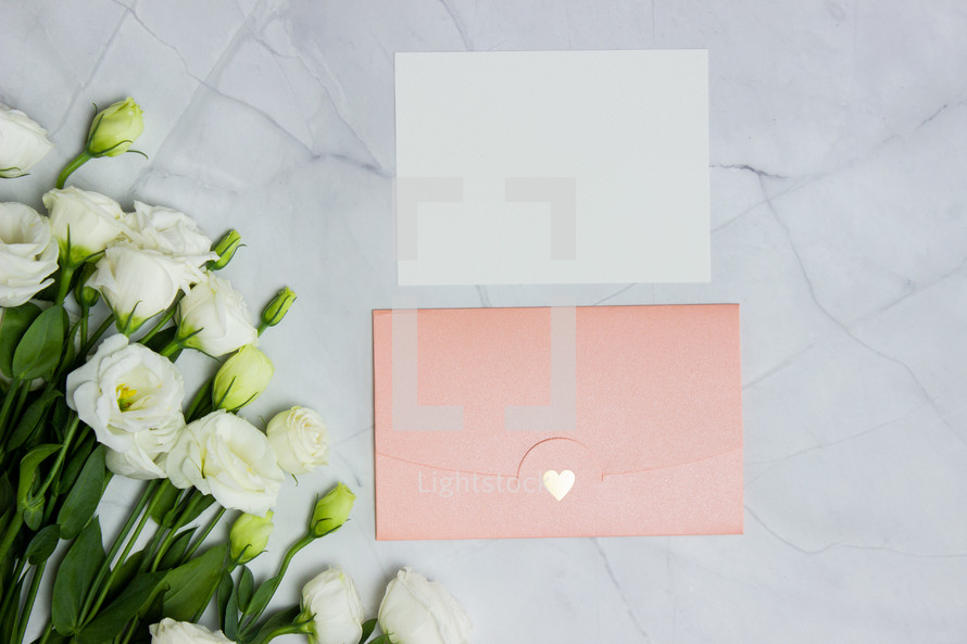 pink envelope and white roses 