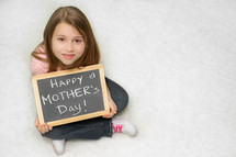girl holding a Happy Mother's day sign