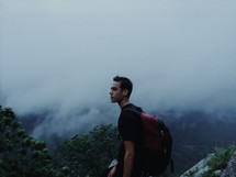 man with a backpack on a foggy mountain 