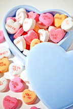 Candy hearts in a heart-shaped bowl.