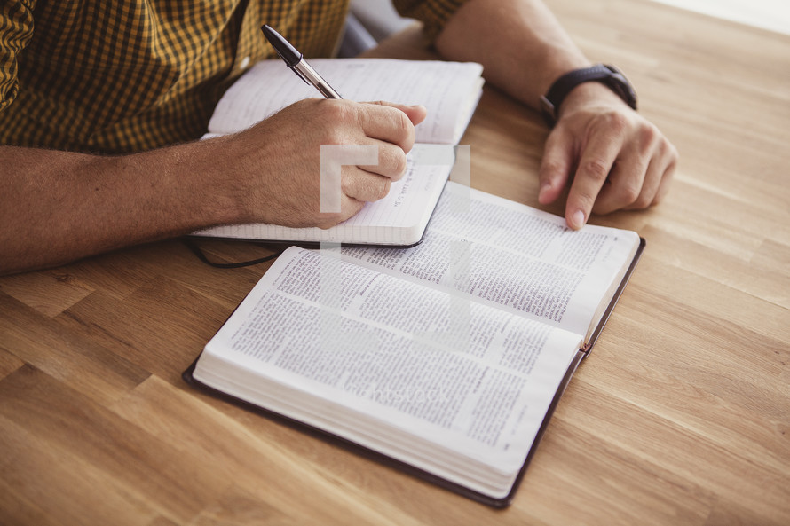 reading a Bible and writing in a journal