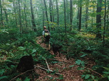 hiking through a forest with a dog 