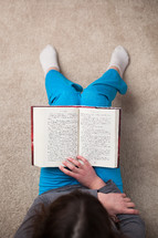 girl sitting reading a Bible 