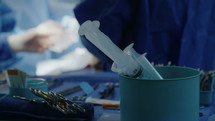 Close up on hands and instruments as surgeons working during open heart surgery.