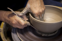 shaping clay on a potters wheel 