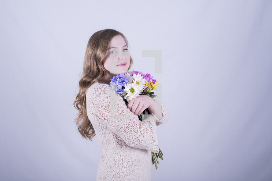  a girl holding a bouquet of flowers