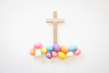 Wood cross with easter eggs on white background