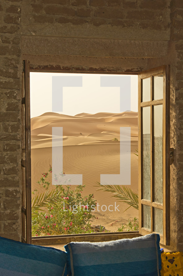 view of desert sand dunes through a window 