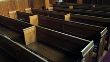 Wooden church pews slow pan from above