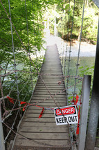 danger keep out sign on a swinging bridge 