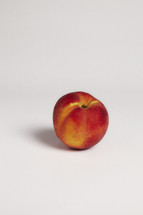 Single peach on seamless white