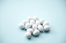 speckled Easter candy on a blue background