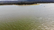 Drone Shot Ascending Over Big Bear Lake and Panning Up with Boats in View