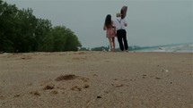 couple walking together on a beach 