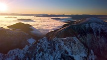 Panorama of golden sunrise in wild mountains in beautiful winter landscape Aerial view Foggy nature
