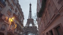 The majestic Eiffel Tower as seen from the residential area of Rue de l'Université, Paris.