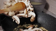 Pouring Sliced And Chopped Mushrooms Into Frying Pan - Close Up