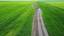 Car driving in field aerial view	