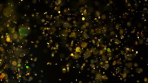 Sparkles in water. Golden glitter paint in water, abstract cloud formations on black background. Can be used as gloss transitions, added to art modern projects. Slow motion