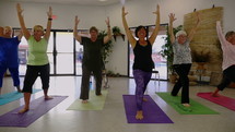 Senior women doing poses at a yoga class 