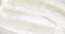 Macro slow motion of vanilla ice cream with scoop