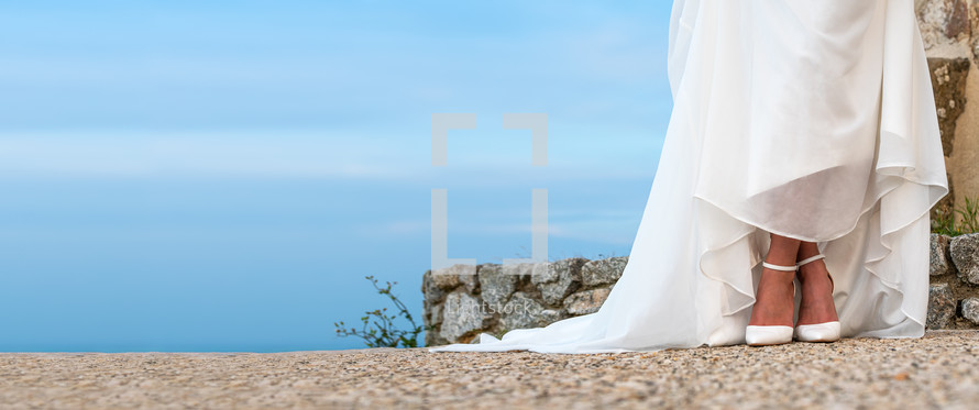  Woman in wedding dress with white shoes outdoors