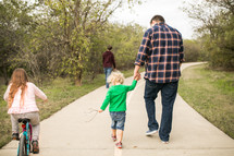 a family taking a walk outdoors 