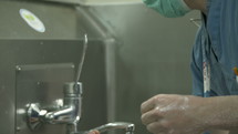 Surgeon washing his hands carefully before starting surgery.