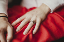 A woman displays her engagement ring on her left hand.