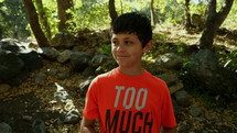 A boy hamming it up in front of the camera showing different expressions