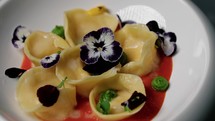 Colorful Cappelletti Pasta With Tomato Cream And Flowers 