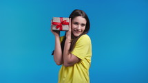 Excited woman received gift box with bow. 