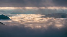 Mystic mountain hidden in dramatic clouds in alpine nature, window between misty clouds sky in foggy autumn landscape Time-lapse 4K
