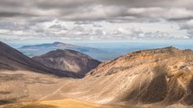 Grey clouds sky moving over volcanic mountains nature in sunny summer day in Tongariro park Time-Lapse

