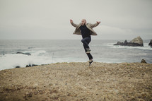 Man jumping for joy on the beach.