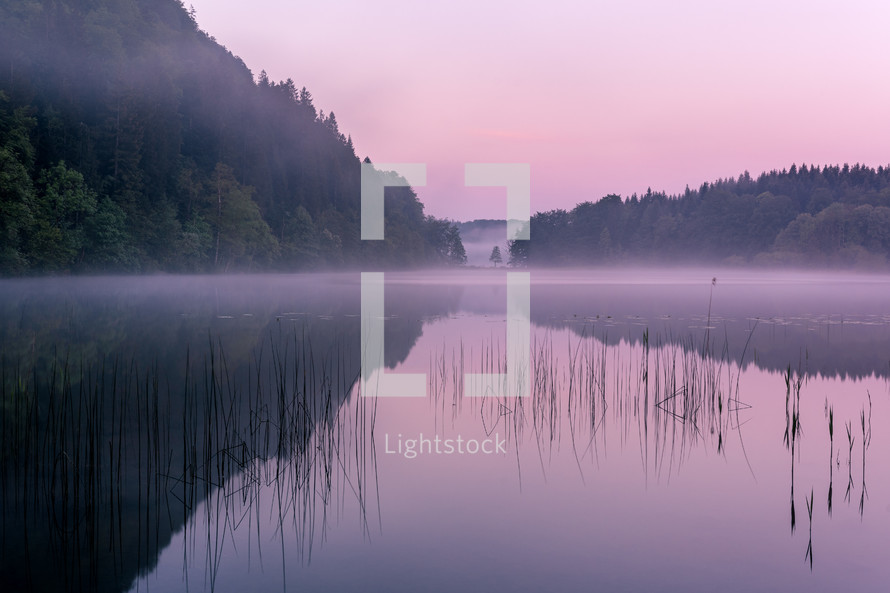 morning mist over a lake at sunrise 
