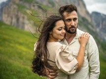 engagement portrait on a green mountainside 