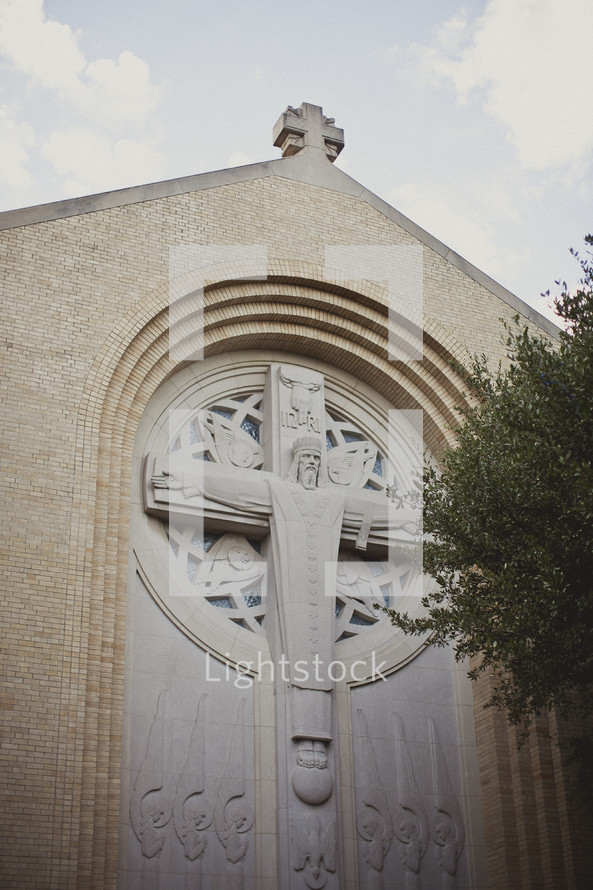 A crucifix sculpture as part of a church building's architecture