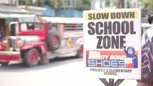 slow down school zone sign 
