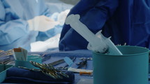 Close up on hands and instruments as surgeons work during open heart surgery.