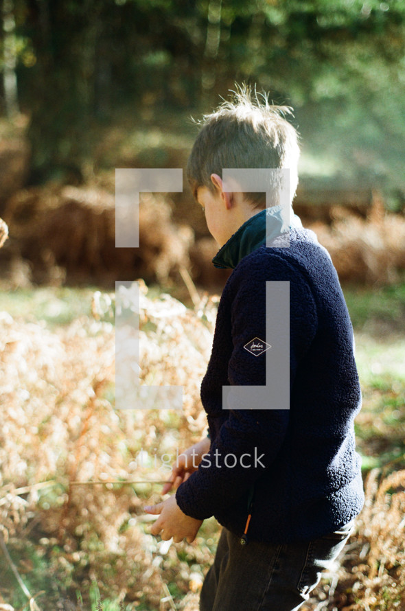 a boy playing outdoors in fall 