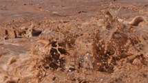 Brown Water of Muddy flooded river splashing after heavy rain Slow motion
