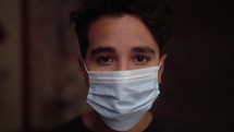 man putting on a surgical mask 